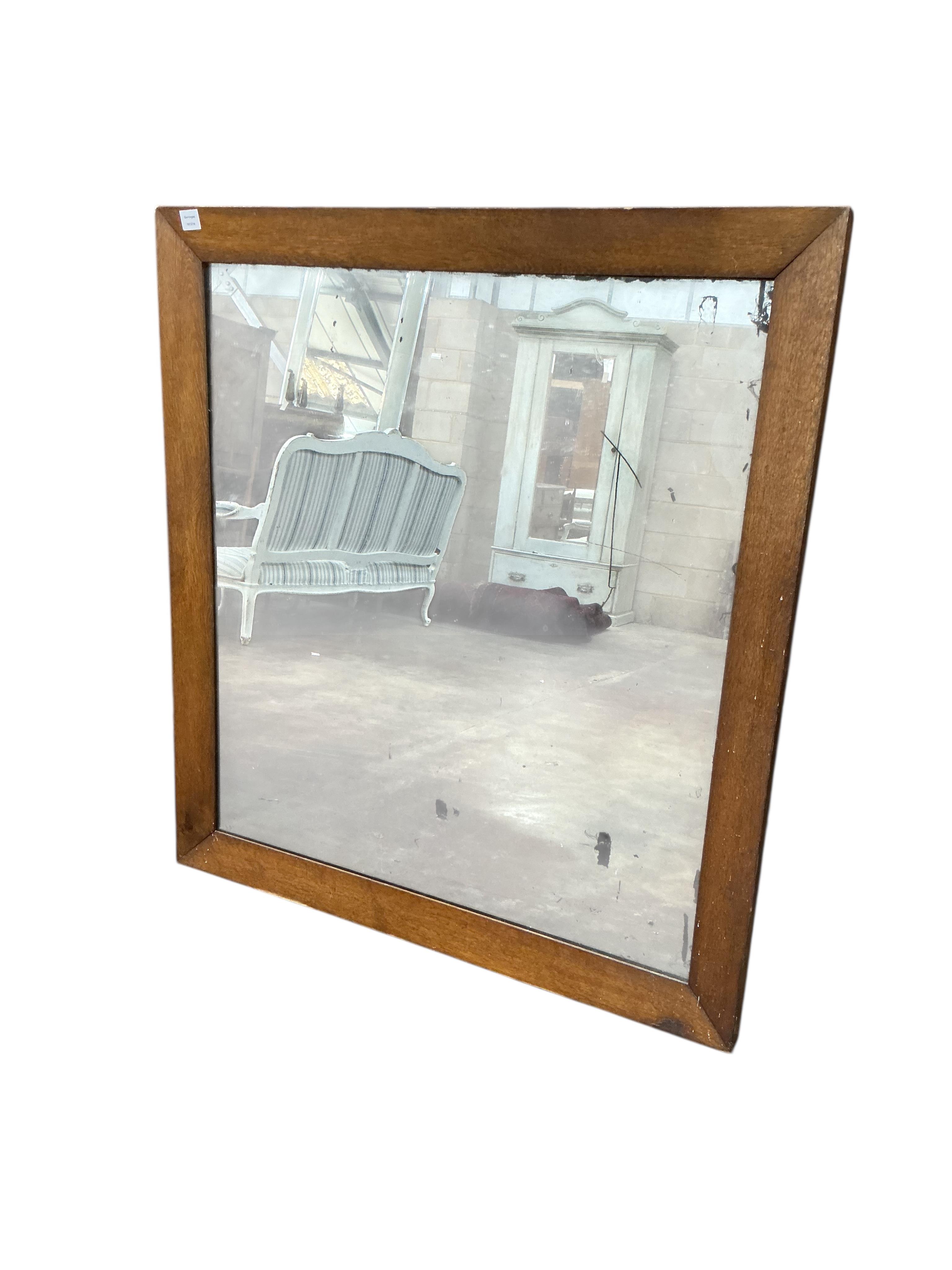 An Edwardian rectangular oak framed wall mirror with foxed plate, width 115cm, height 125cm